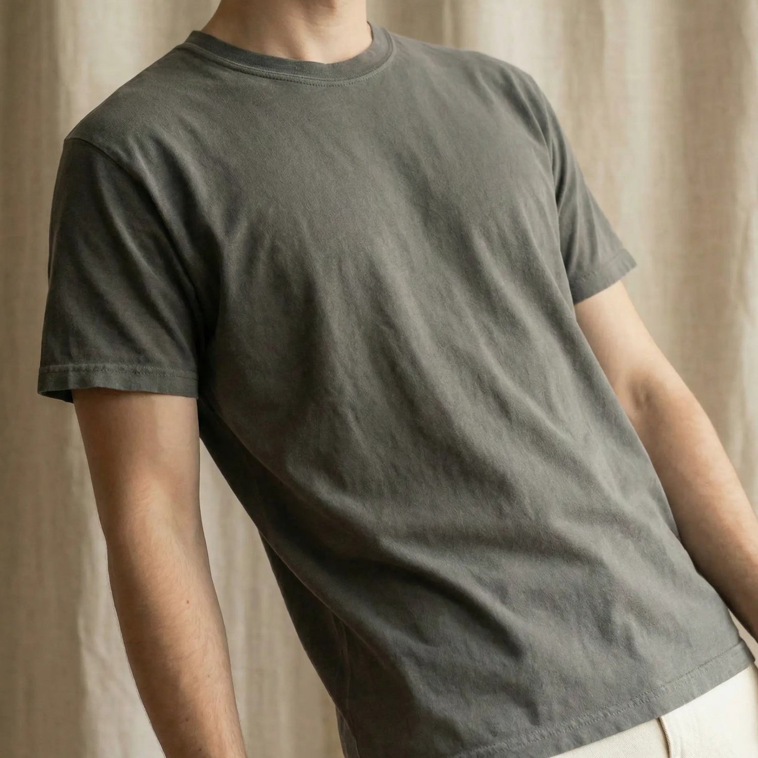 Person leaning back wearing charcoal minimalist t-shirt